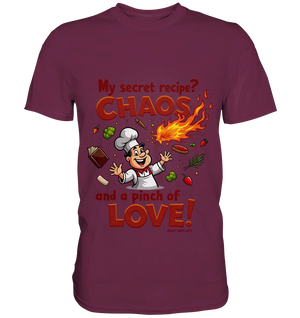 Ein cartoonhafter Koch mit weißem Kochhut und weiß-rotem Kochkittel, der fröhlich und mit ausgestreckten Armen lacht. Er steht inmitten eines Wirbels von Zutaten, darunter Flammen, Gemüse, Tomaten, und ein Kochbuch, die in der Luft herumfliegen. Der Koch Bright Lights Arts