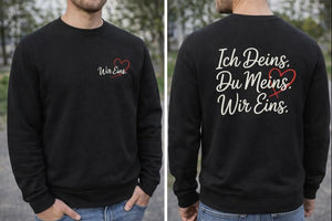 Schwarzes Premium Sweatshirt mit dezentem „Wir Eins“-Brustdruck und großem Liebes-Statement „Ich Deins. Du Meins. Wir Eins.“ auf dem Rücken – minimalistisches Unisex-Sweatshirt für Paare