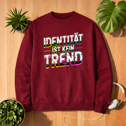 Bordeauxfarbenes Unisex Sweatshirt mit Aufdruck „Identität ist kein Trend“ im Bright Lights Arts Mockup auf Holzuntergrund mit Pflanzen und Kopfhörern