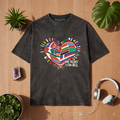 Washed Black Oversized Shirt mit One Heart for All Weltflaggen Herz Design auf Holz Hintergrund mit Pflanzen und Kopfhörern – Bright Lights Arts Mockup