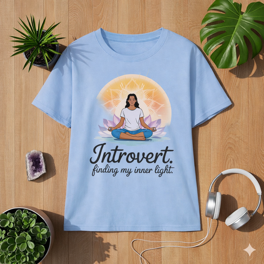 Light blue women’s t-shirt with meditating woman mandala design and introvert finding my inner light quote, soft mindfulness yoga shirt by Bright Lights Arts