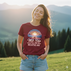 rau in bordeauxrotem Bio-T-Shirt genießt lachend die Abendsonne in den Bergen, weiches Licht, emotionaler Vibe.